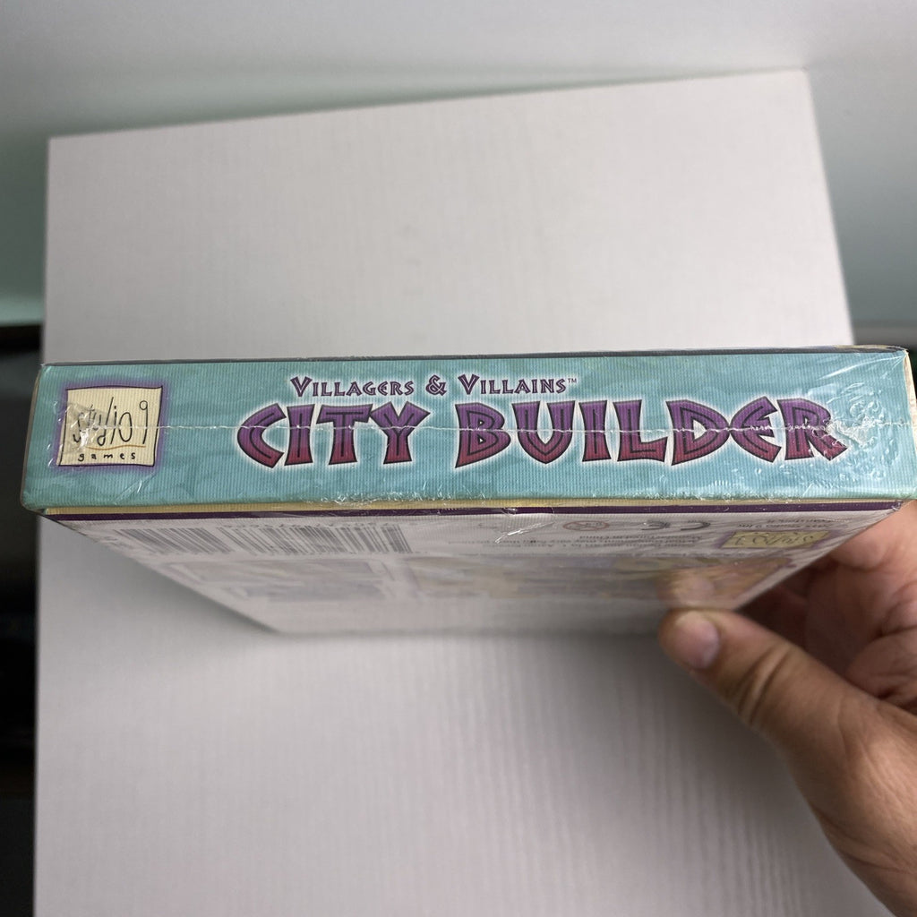 Studio 9 Games Villagers & Villains City Builder tabletop game expansion box in protective wrap
