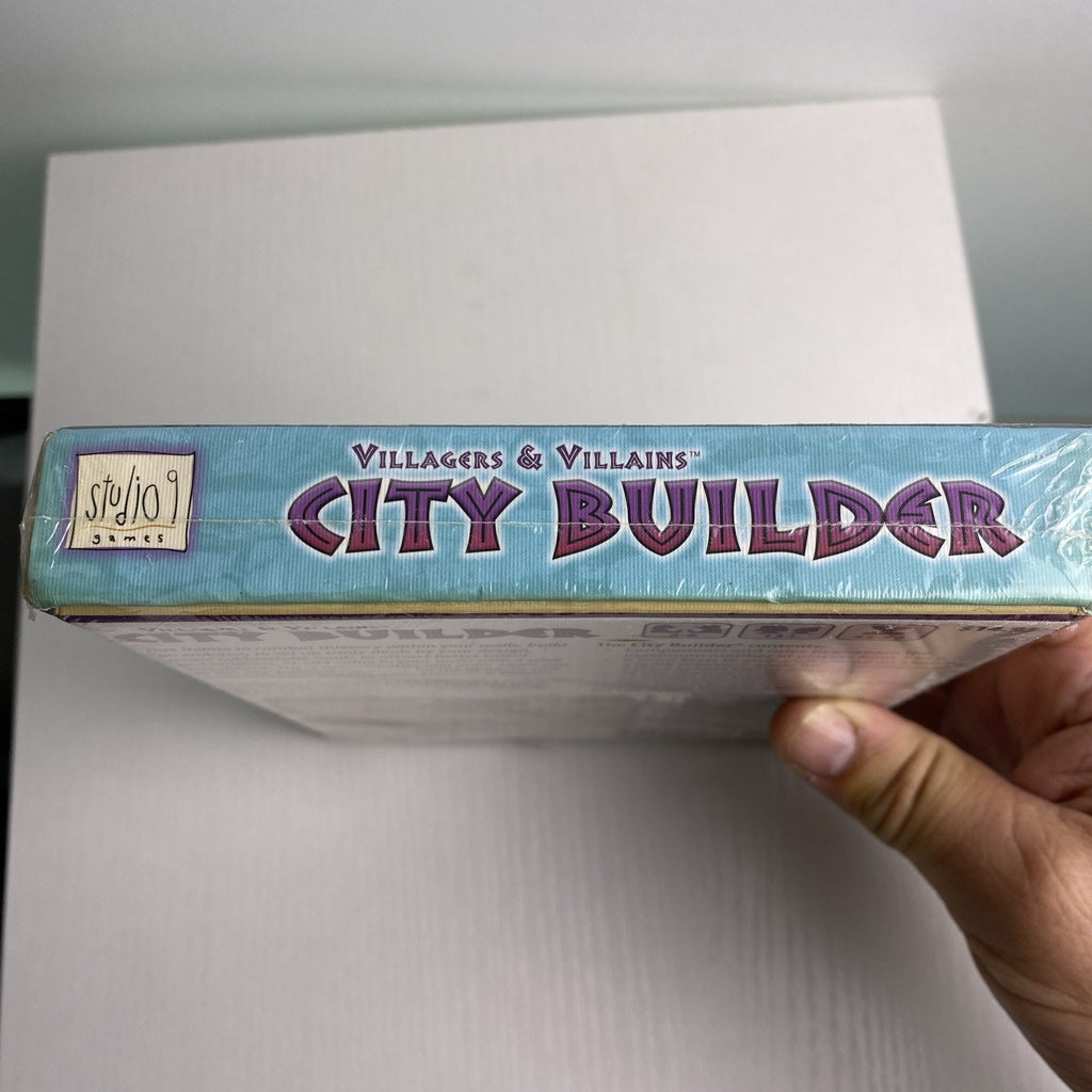 Studio 9 Games Villagers & Villains City Builder tabletop game expansion box in protective wrap