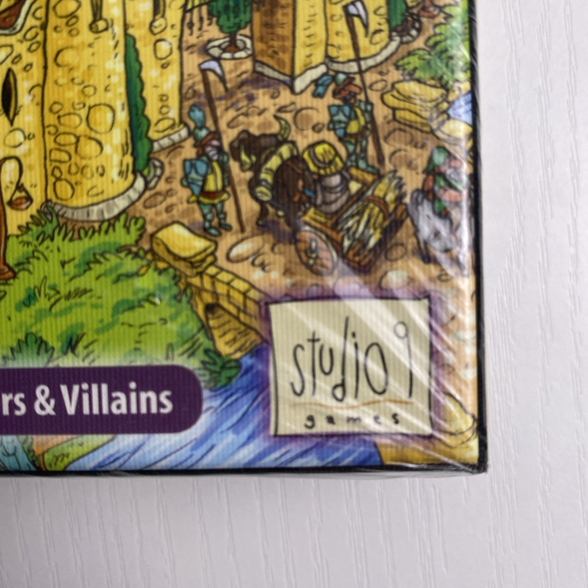 Studio 9 Games Villagers & Villains City Builder tabletop game expansion box in protective wrap