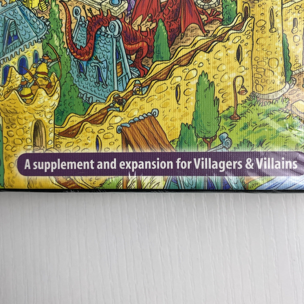 Studio 9 Games Villagers & Villains City Builder tabletop game expansion box in protective wrap