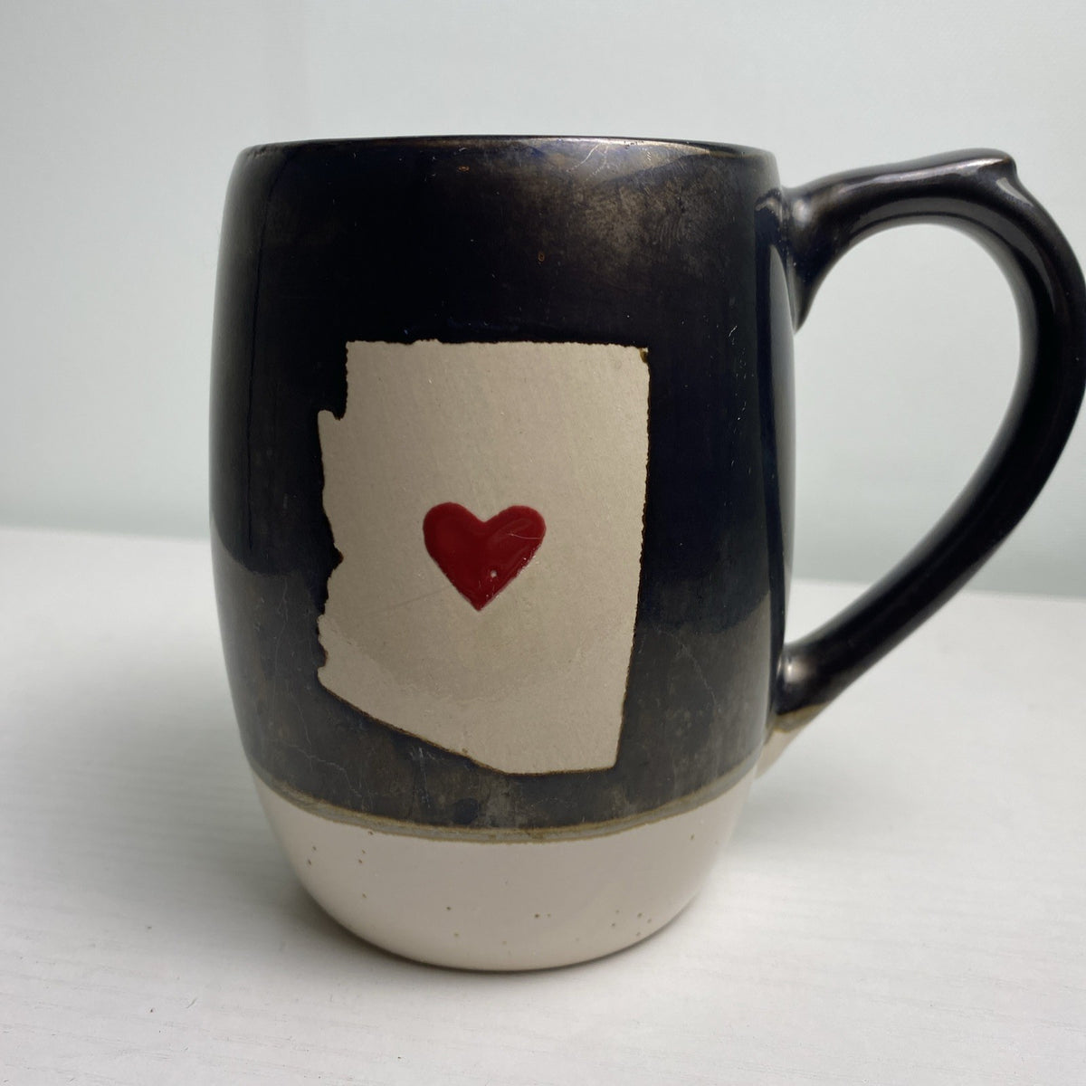 Big Sky Carvers Bearizona stoneware coffee mug with bronze metallic glaze and Arizona map