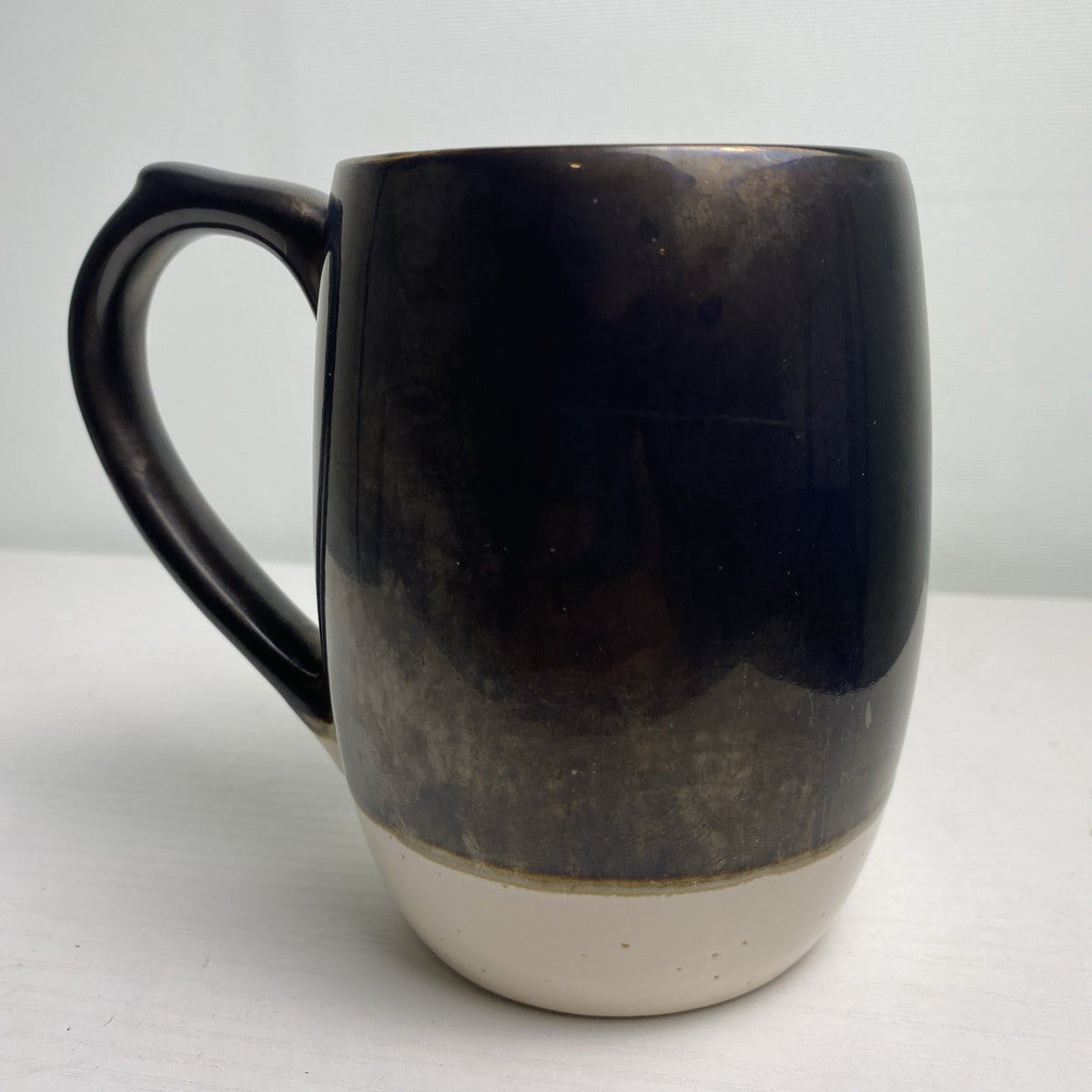 Big Sky Carvers Bearizona stoneware coffee mug with bronze metallic glaze and Arizona map