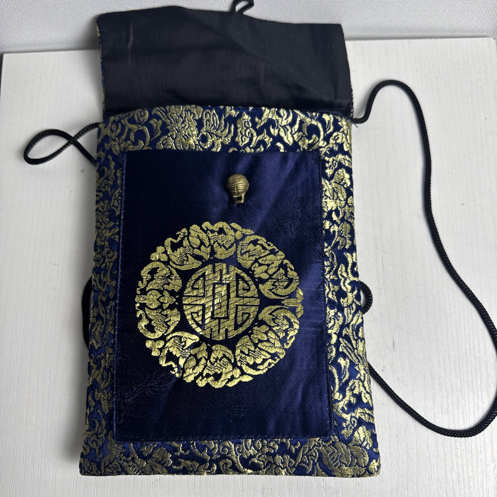 Chinese cobalt blue and gold silk brocade neck pouch featuring a Shou longevity medallion and brass bell toggle