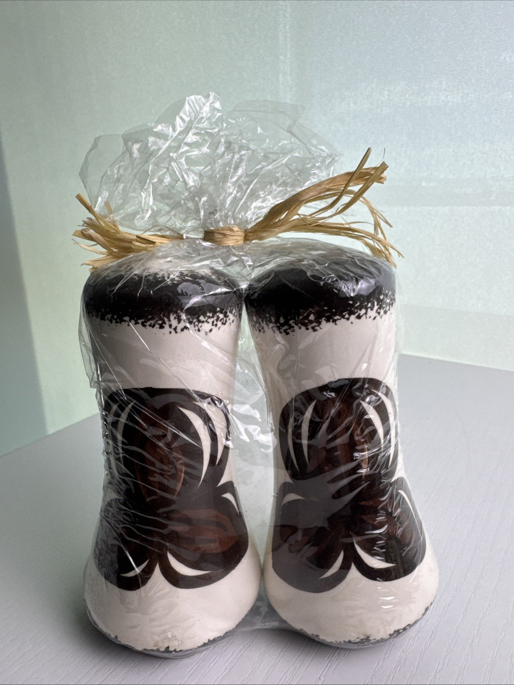 Hawaii by Elle brown and white floral ceramic salt and pepper shakers in original raffia-tied wrap