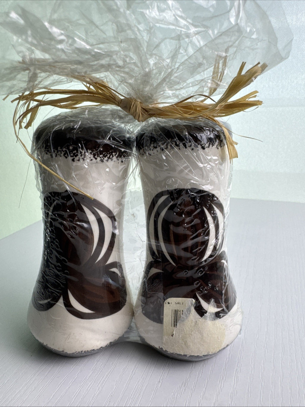 Hawaii by Elle brown and white floral ceramic salt and pepper shakers in original raffia-tied wrap