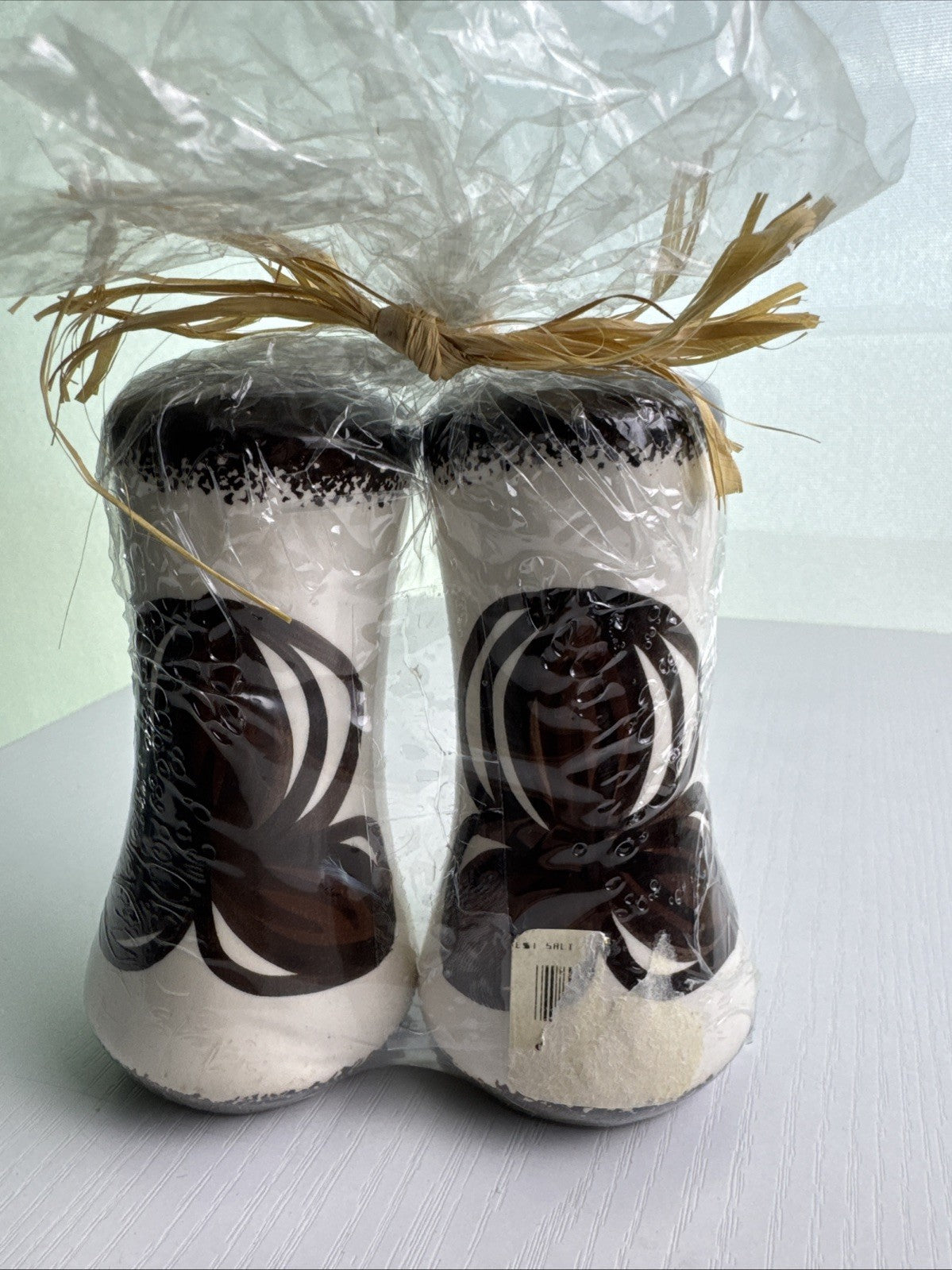 Hawaii by Elle brown and white floral ceramic salt and pepper shakers in original raffia-tied wrap