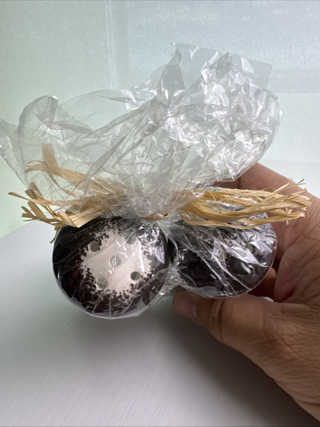 Hawaii by Elle brown and white floral ceramic salt and pepper shakers in original raffia-tied wrap