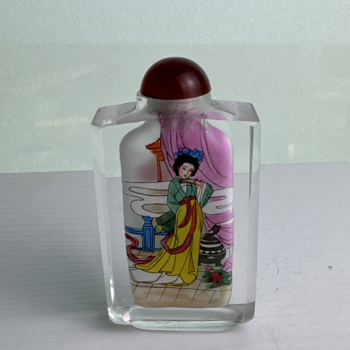 Vintage Chinese inside-painted faceted crystal snuff bottle featuring Yang Guifei with red stopper