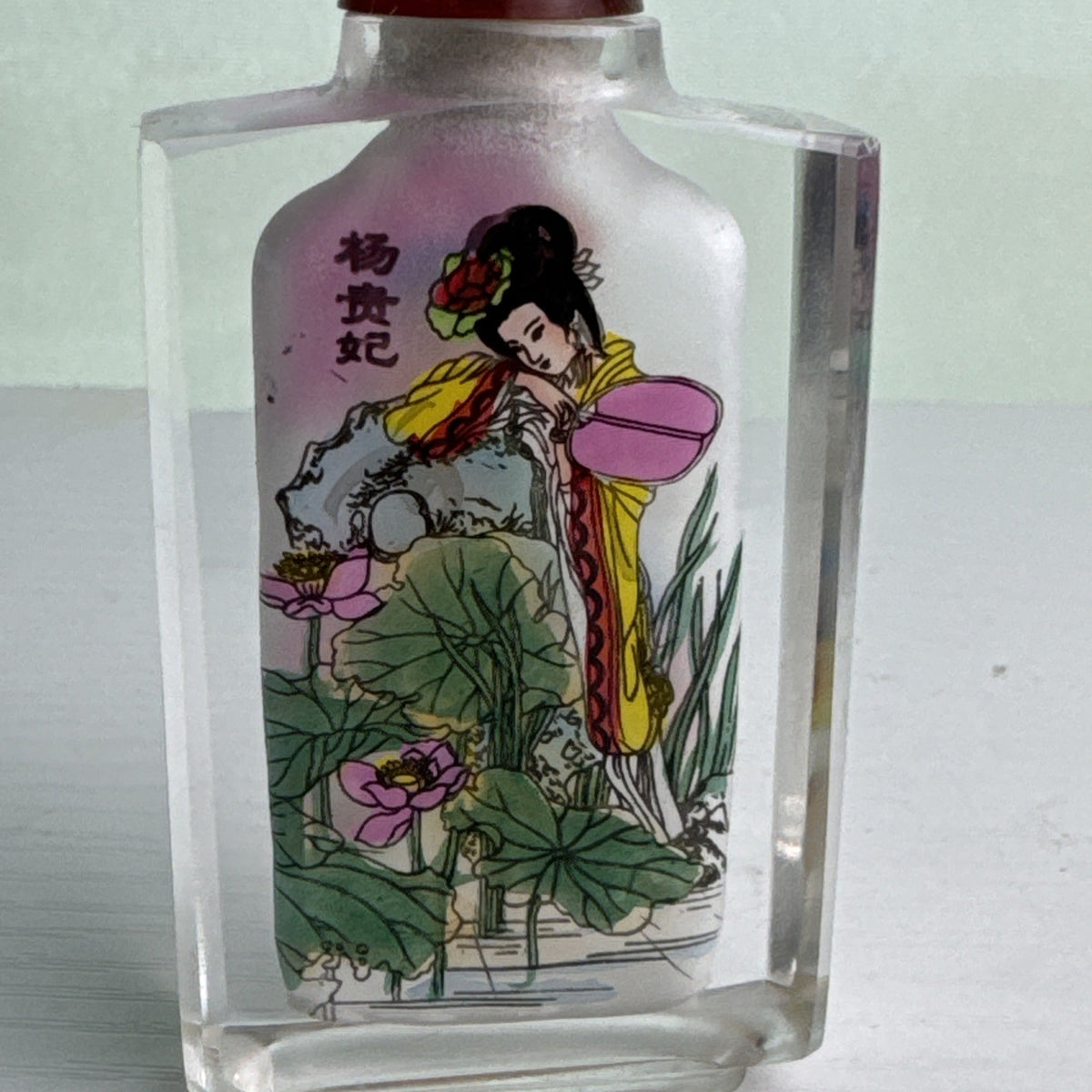 Vintage Chinese inside-painted faceted crystal snuff bottle featuring Yang Guifei with red stopper