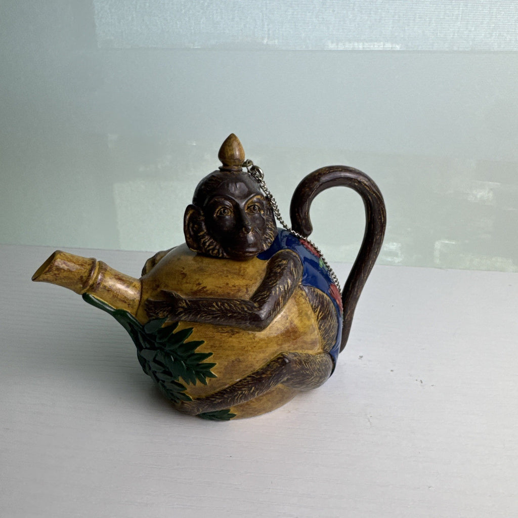 Hand-painted ceramic miniature monkey novelty teapot with bamboo-style spout and chained lid