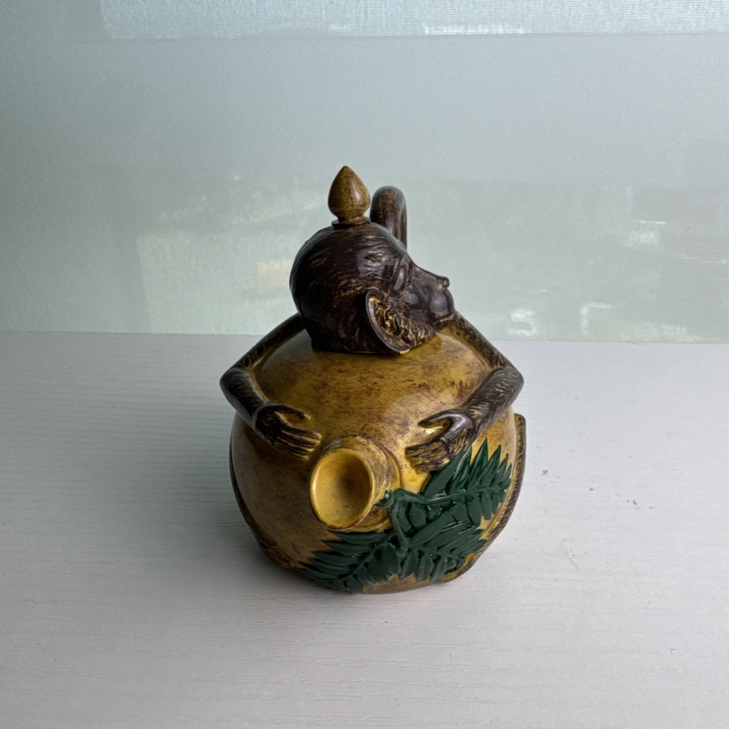 Hand-painted ceramic miniature monkey novelty teapot with bamboo-style spout and chained lid