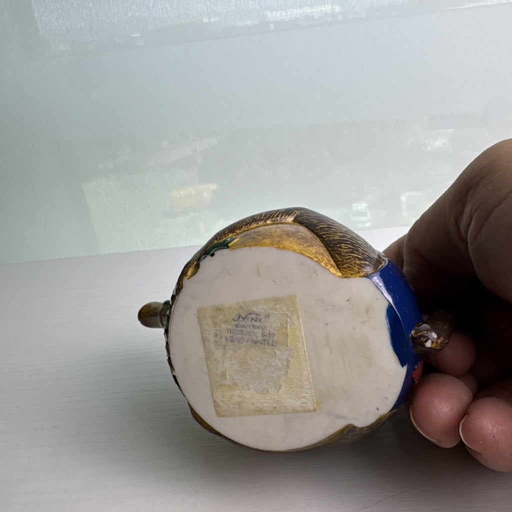 Hand-painted ceramic miniature monkey novelty teapot with bamboo-style spout and chained lid