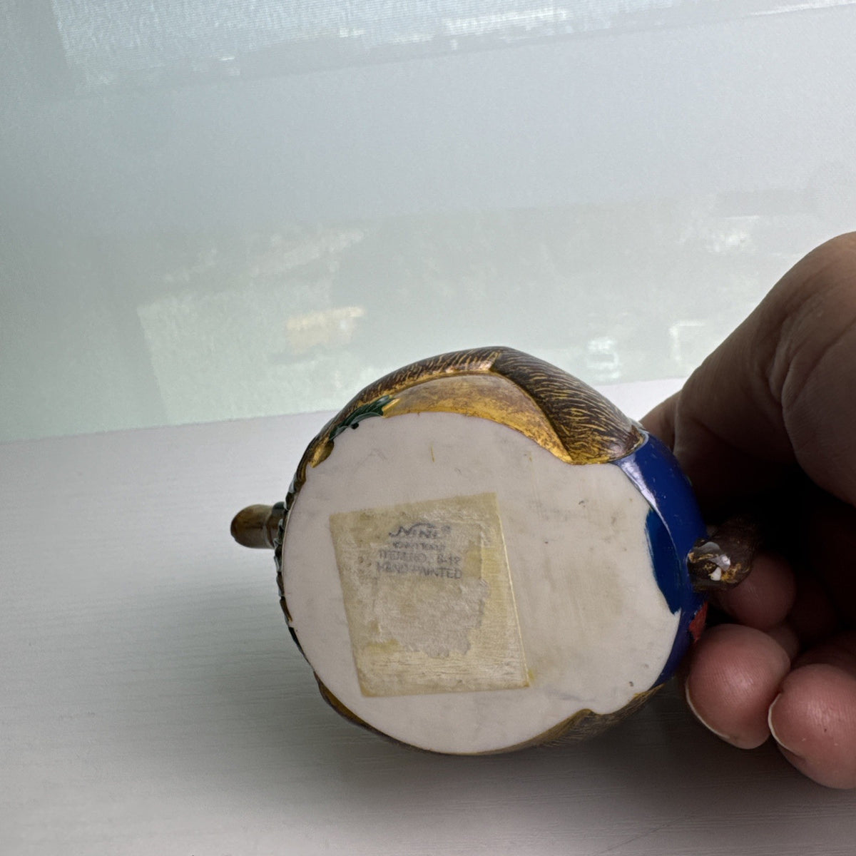 Hand-painted ceramic miniature monkey novelty teapot with bamboo-style spout and chained lid