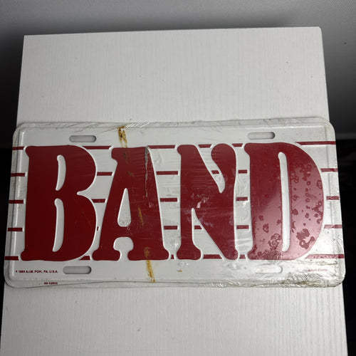 1989 Albert Elovitz embossed metal BAND music novelty license plate, 6x12 inches sealed in original plastic.