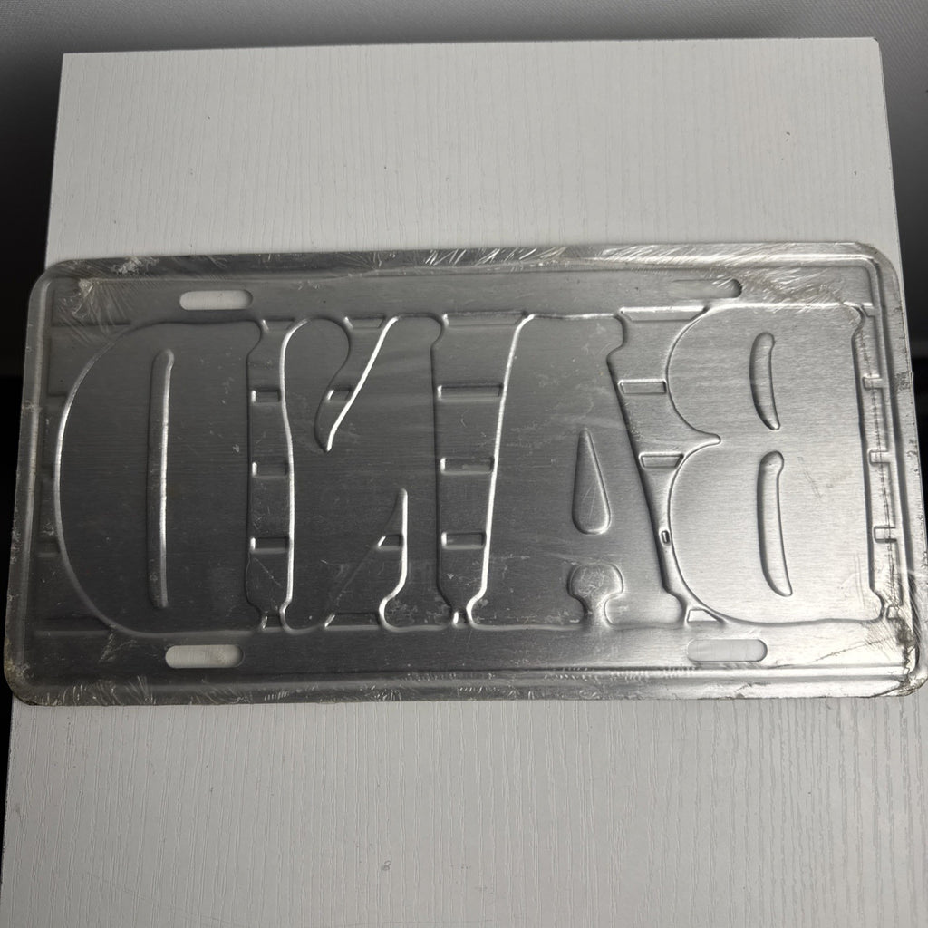 1989 Albert Elovitz embossed metal BAND music novelty license plate, 6x12 inches sealed in original plastic.