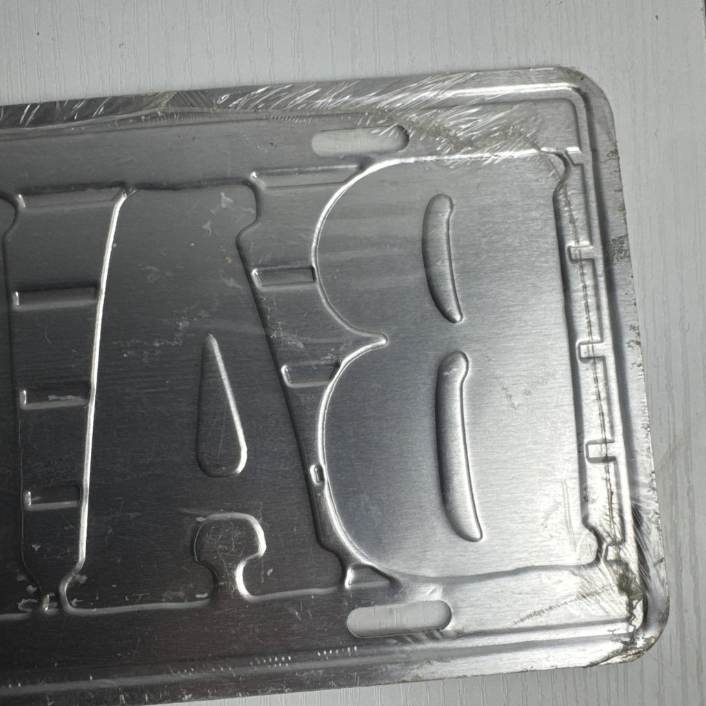 1989 Albert Elovitz embossed metal BAND music novelty license plate, 6x12 inches sealed in original plastic.