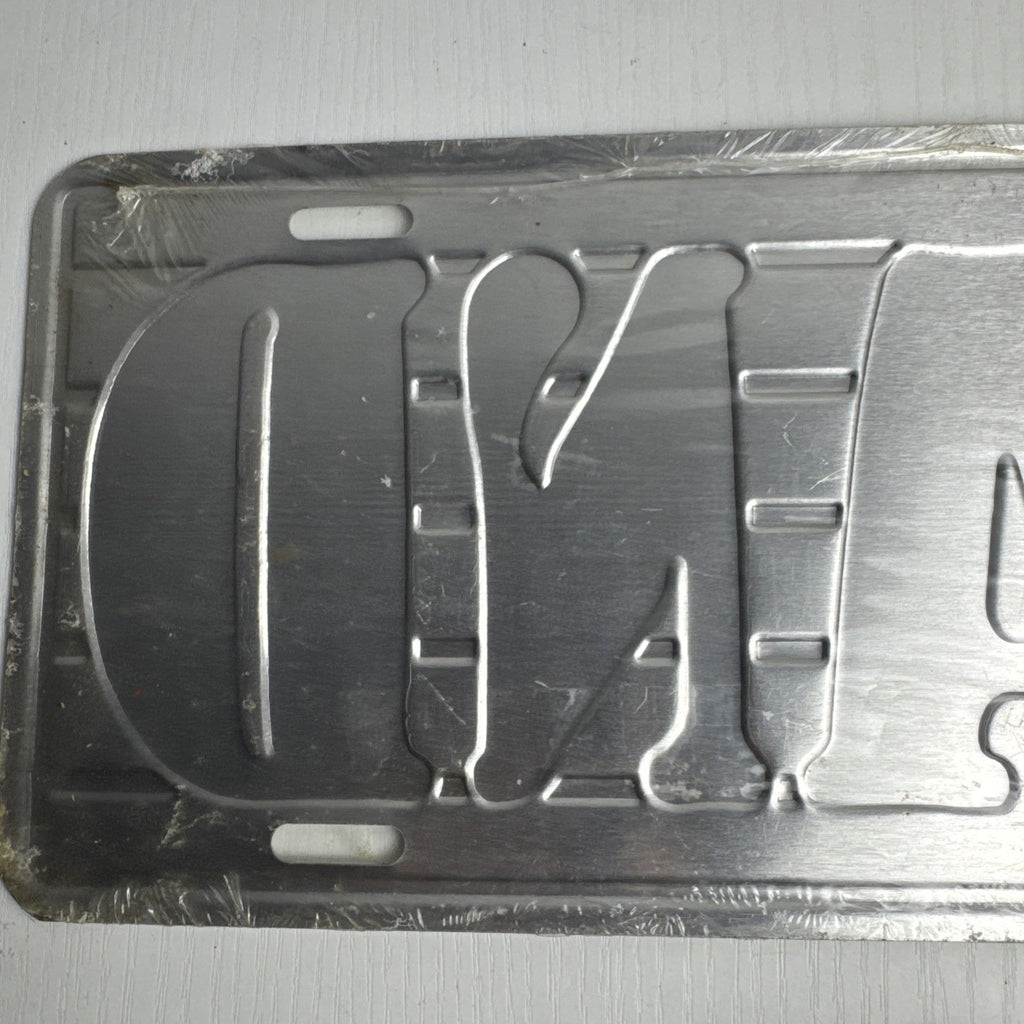 1989 Albert Elovitz embossed metal BAND music novelty license plate, 6x12 inches sealed in original plastic.