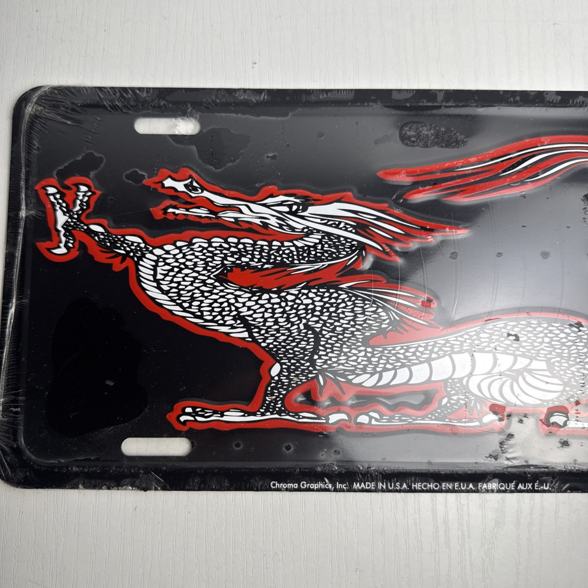 Chroma Graphics embossed metal Asian dragon vanity license plate in black, red, and white