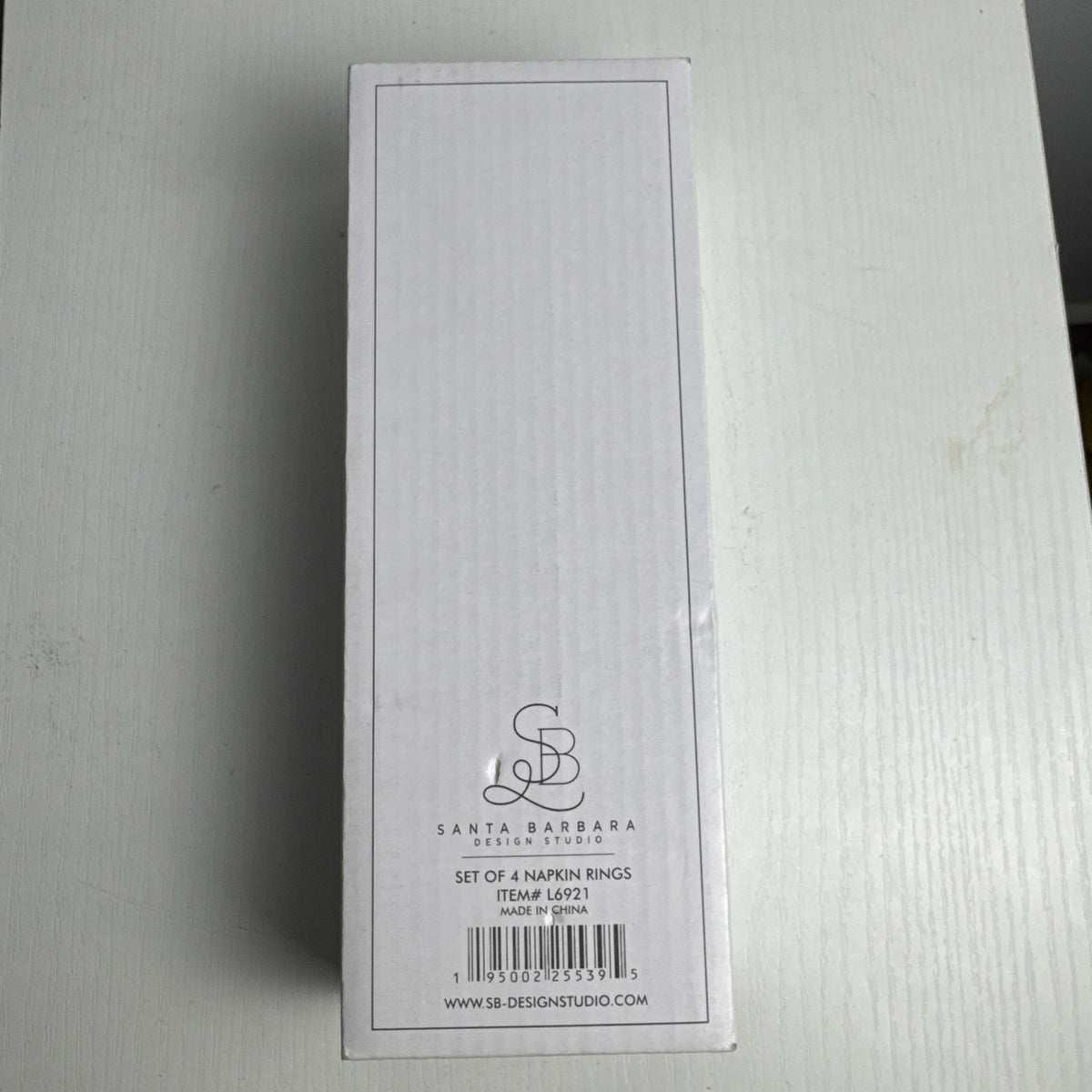 Santa Barbara Design Studio set of four white ceramic napkin rings debossed with entertaining phrases in original box