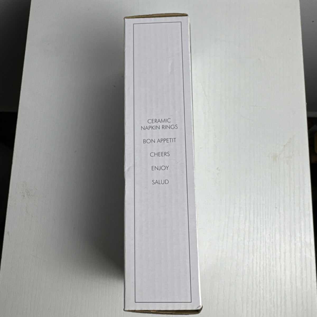 Santa Barbara Design Studio set of four white ceramic napkin rings debossed with entertaining phrases in original box