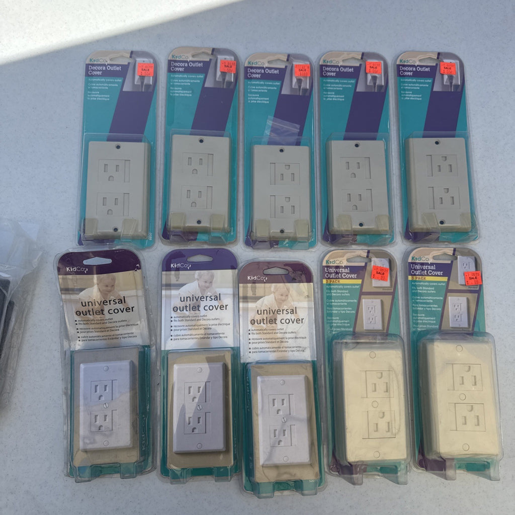 Lot of 10 packaged KidCo auto-closing safety outlet covers in beige and white for standard and Decora outlets.