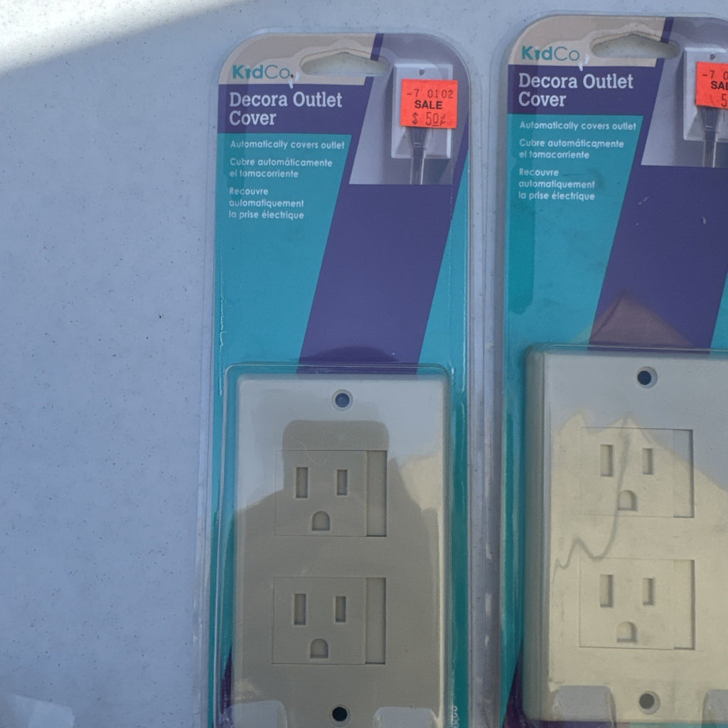 Lot of 10 packaged KidCo auto-closing safety outlet covers in beige and white for standard and Decora outlets.