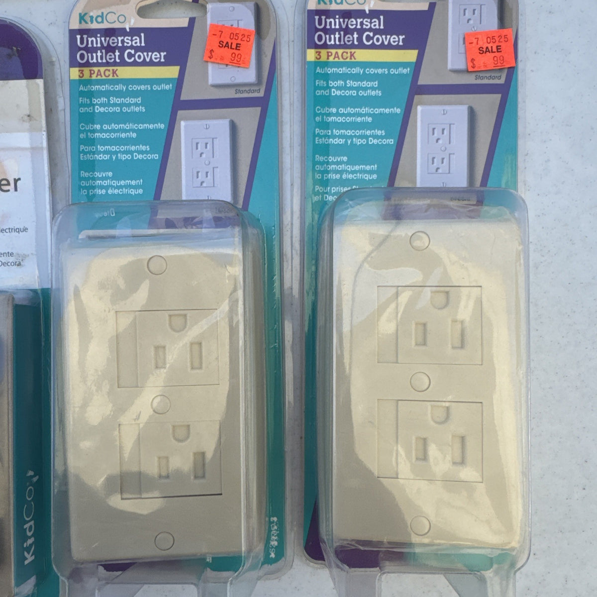 Lot of 10 packaged KidCo auto-closing safety outlet covers in beige and white for standard and Decora outlets.