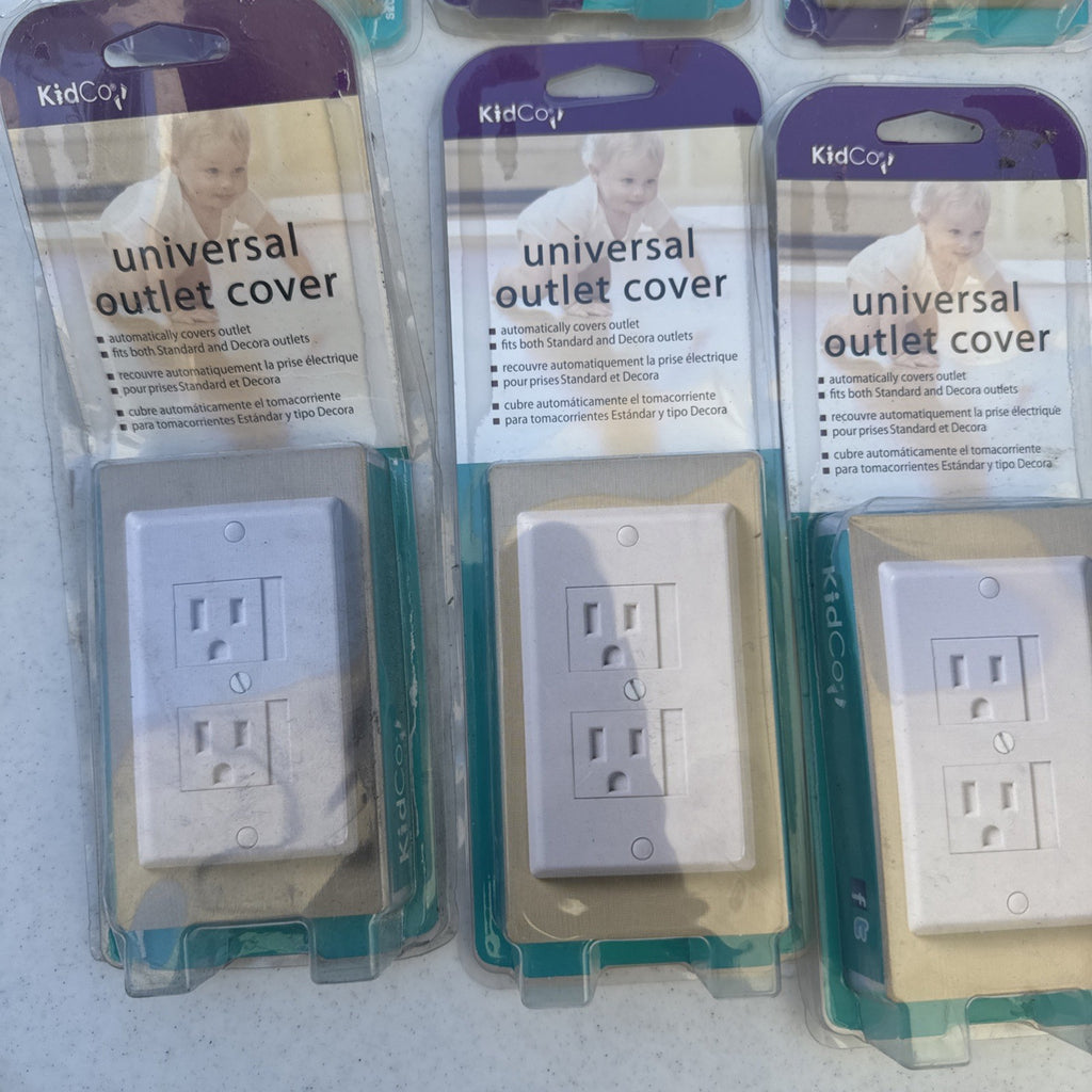 Lot of 10 packaged KidCo auto-closing safety outlet covers in beige and white for standard and Decora outlets.