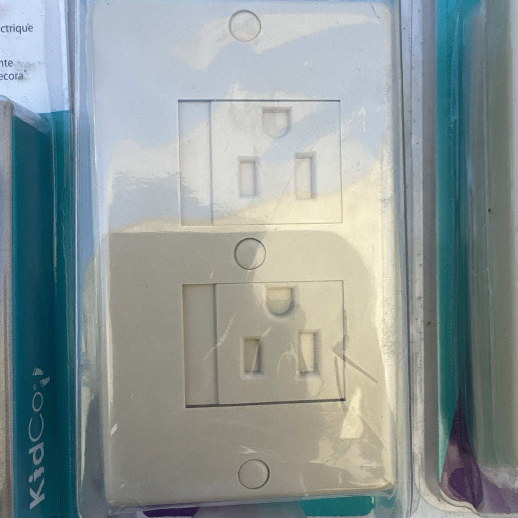 Lot of 10 packaged KidCo auto-closing safety outlet covers in beige and white for standard and Decora outlets.