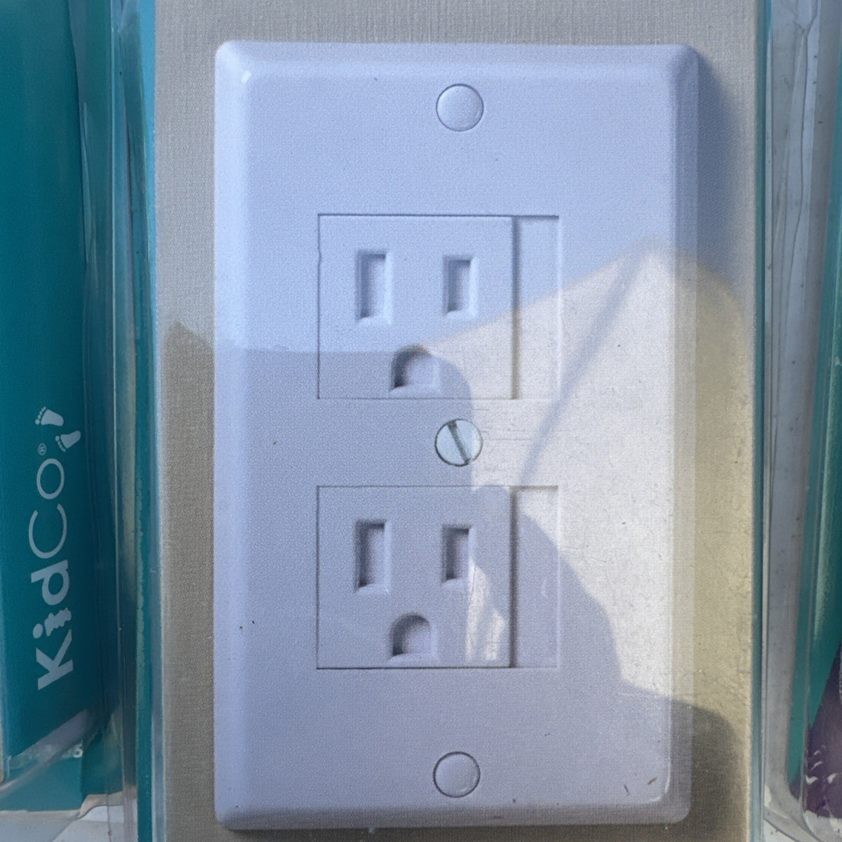 Lot of 10 packaged KidCo auto-closing safety outlet covers in beige and white for standard and Decora outlets.