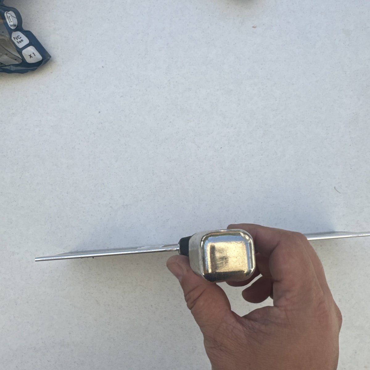 Husky 12 inch blue spring steel taping knife featuring soft grip handle and integrated hammer end