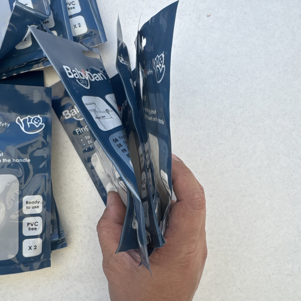 Bulk lot of 25 brand new packs of clear BabyDan FingerSafe door guards, total 50 stoppers.