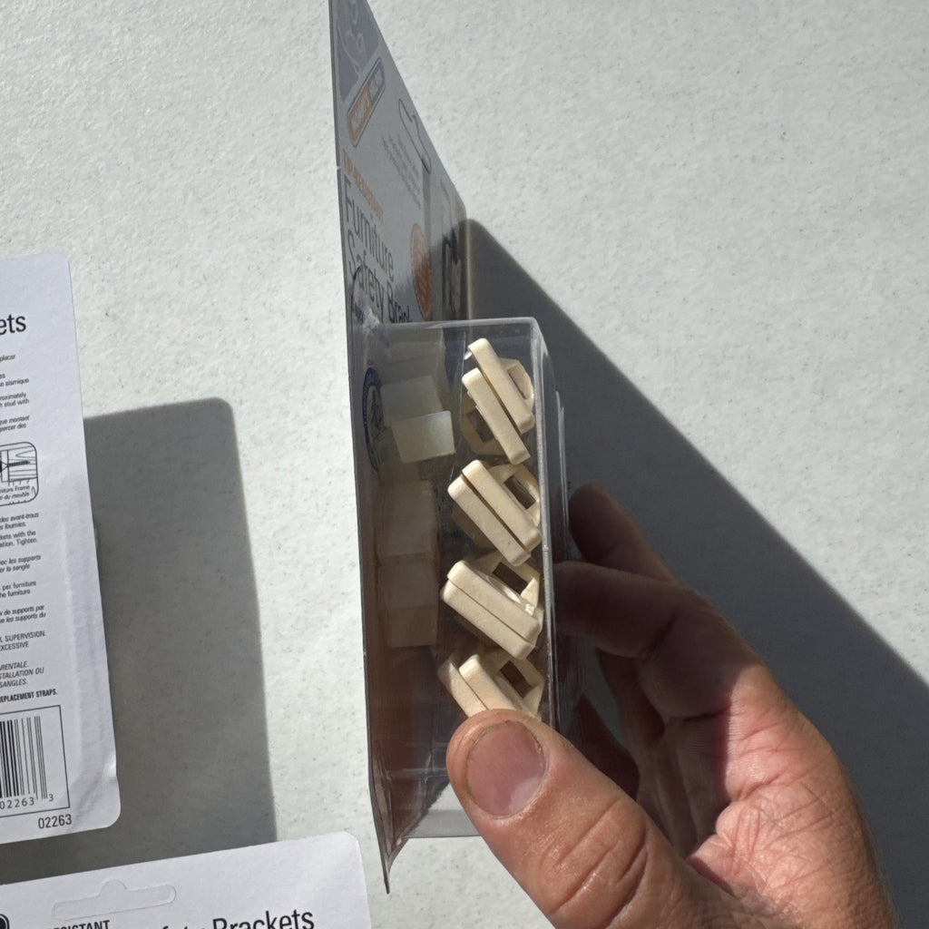 Three sealed packages of Mommy's Helper tip-resistant furniture safety brackets model 02263.