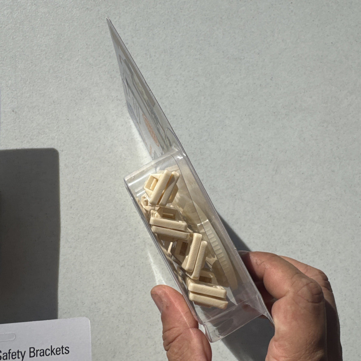 Three sealed packages of Mommy's Helper tip-resistant furniture safety brackets model 02263.