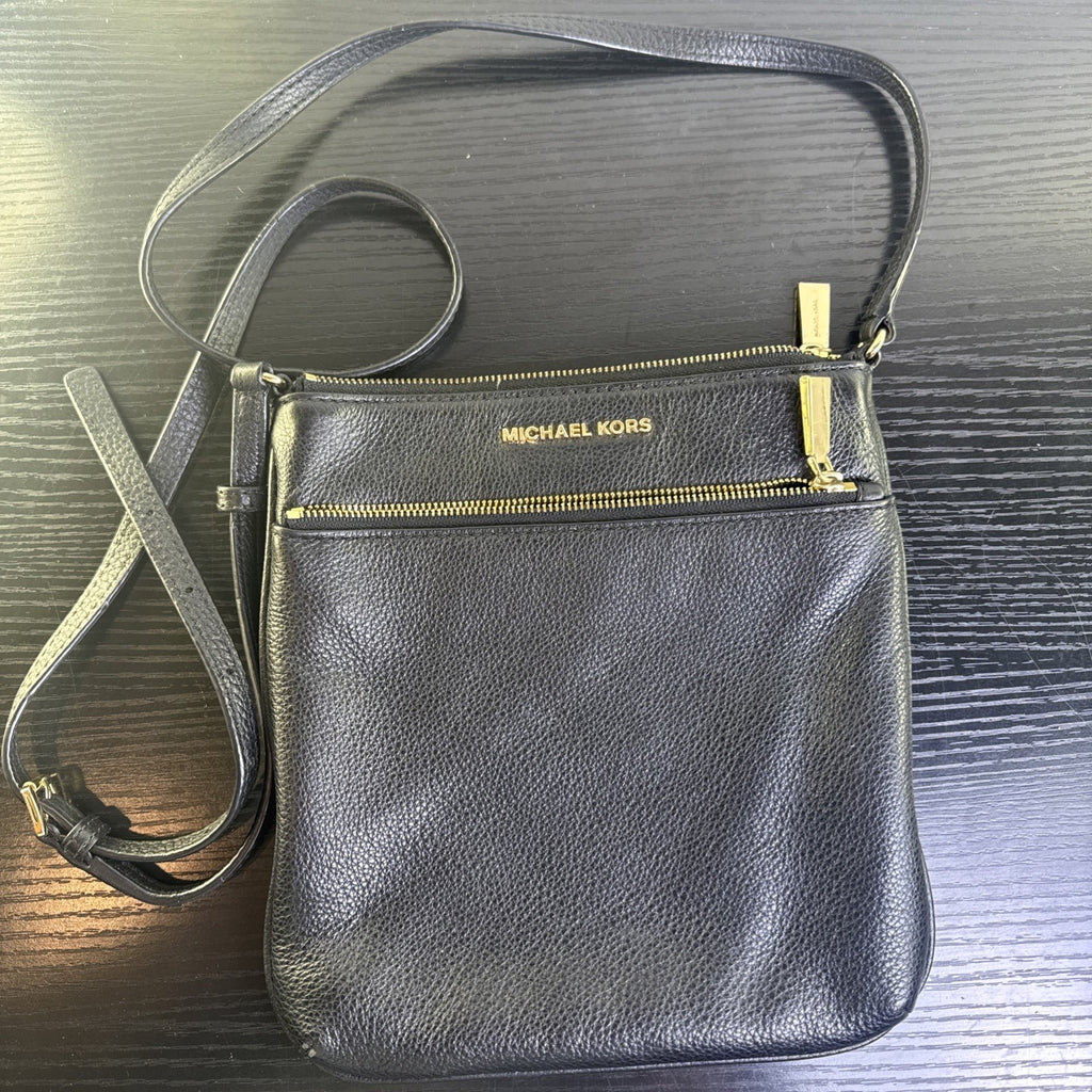 Michael Kors black pebbled leather flat crossbody bag with gold hardware and front zip pocket