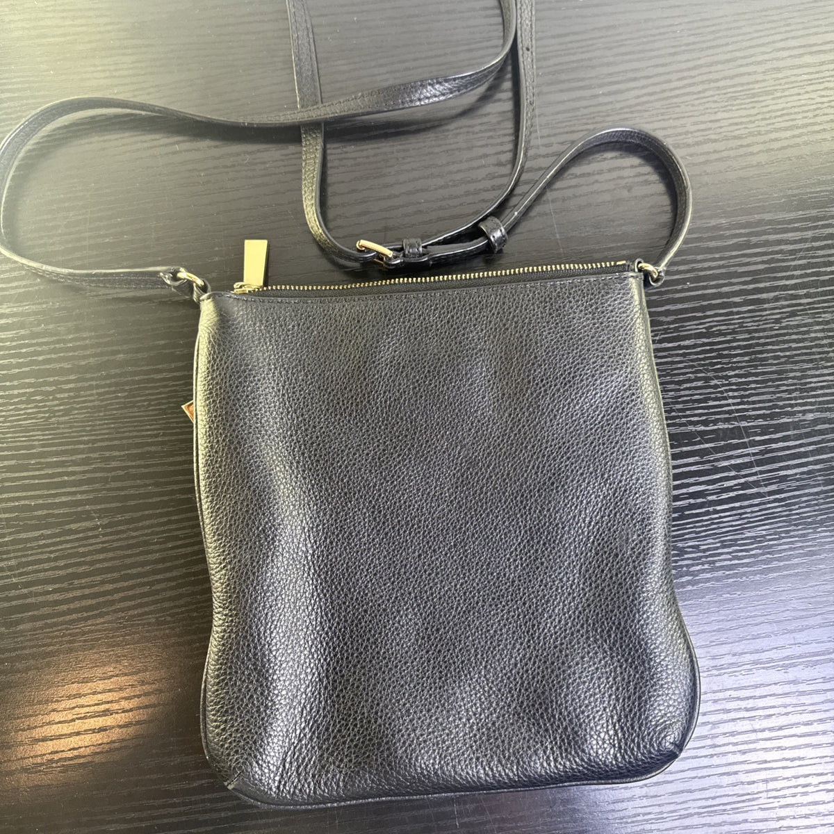 Michael Kors black pebbled leather flat crossbody bag with gold hardware and front zip pocket