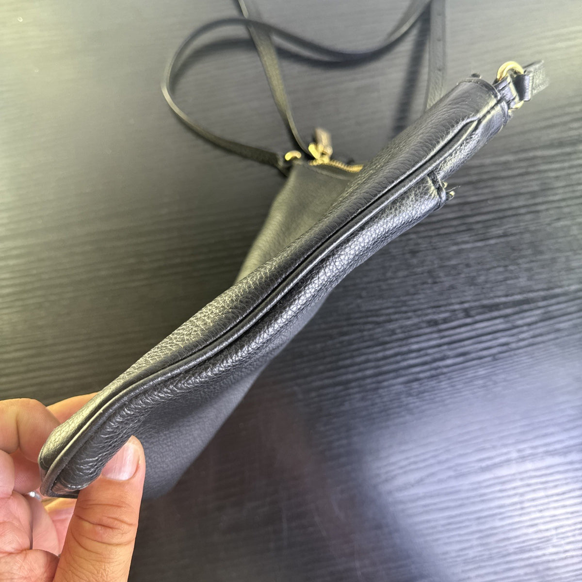 Michael Kors black pebbled leather flat crossbody bag with gold hardware and front zip pocket