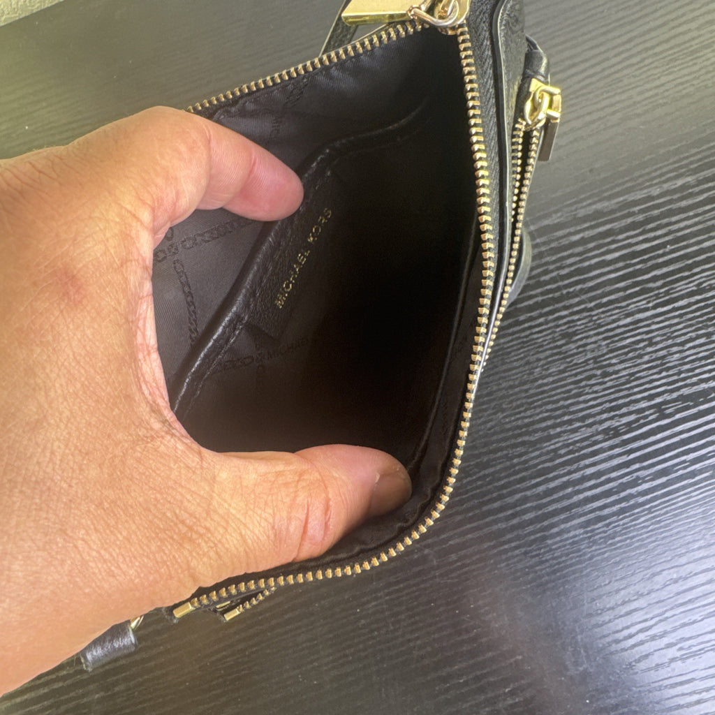 Michael Kors black pebbled leather flat crossbody bag with gold hardware and front zip pocket