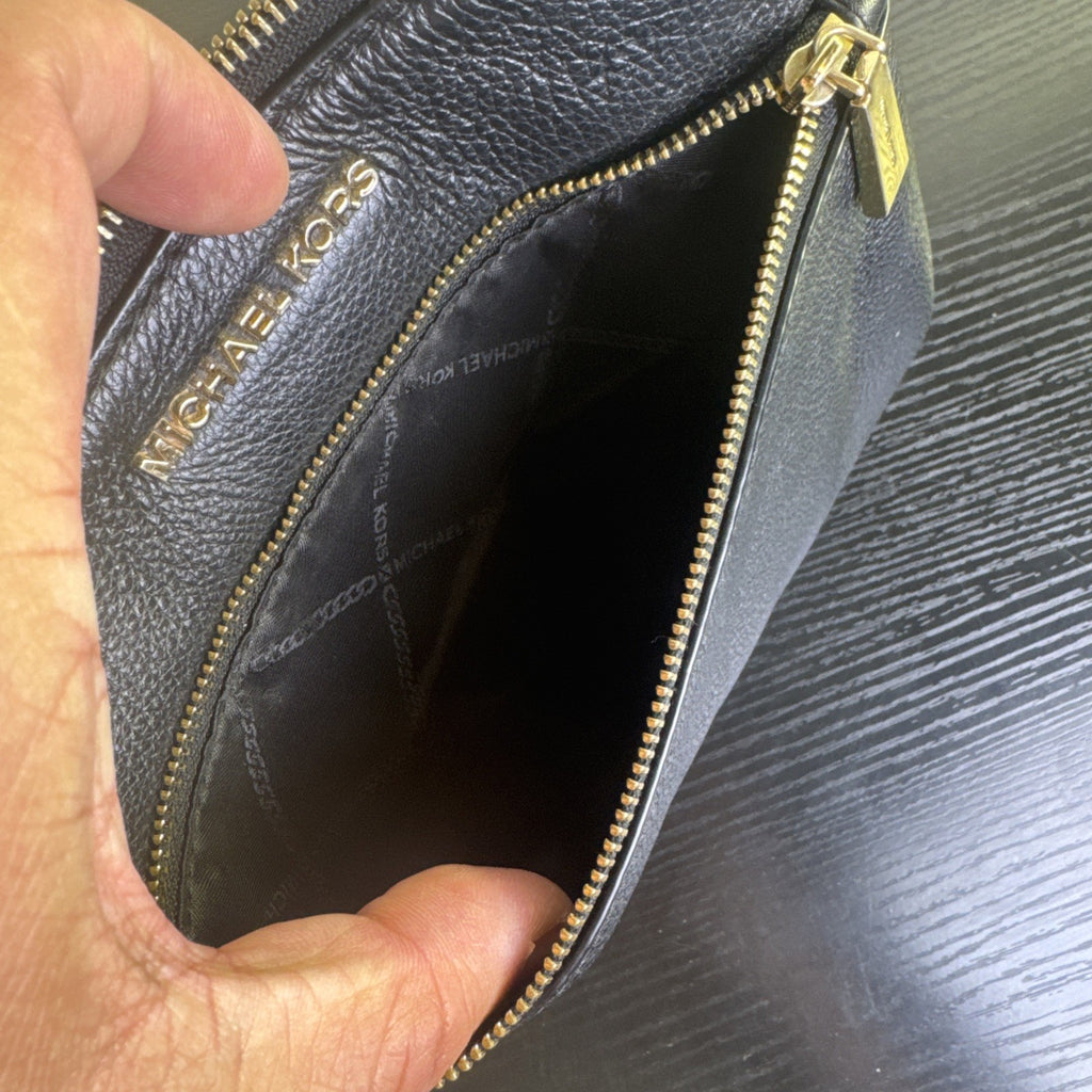 Michael Kors black pebbled leather flat crossbody bag with gold hardware and front zip pocket