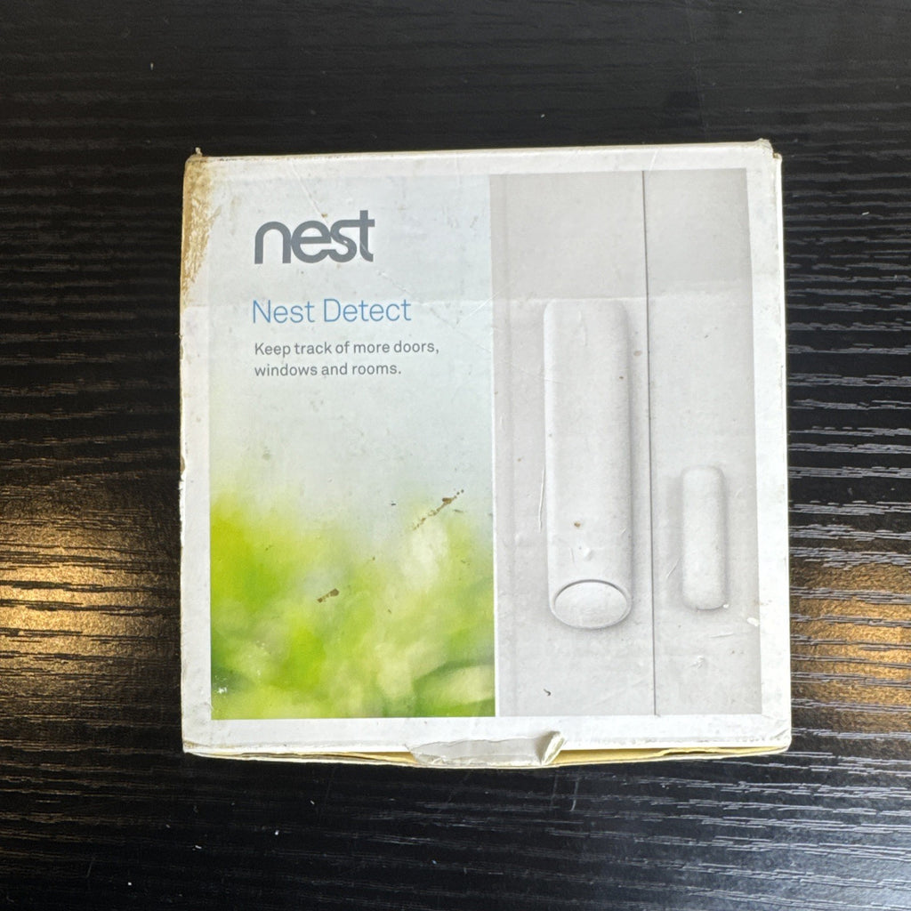 Open box Google Nest Detect H1100WES wireless door and window sensor showing its sleek white design.
