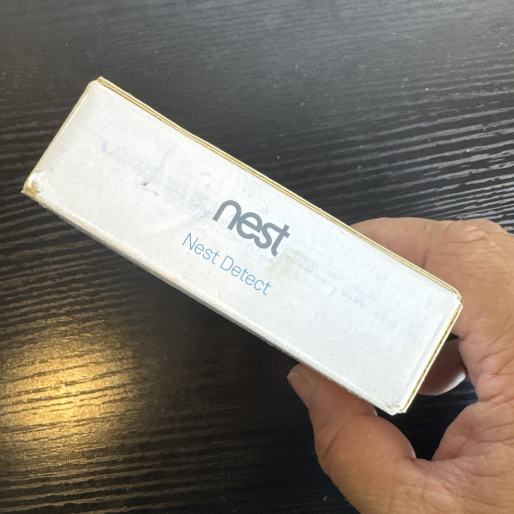 Open box Google Nest Detect H1100WES wireless door and window sensor showing its sleek white design.