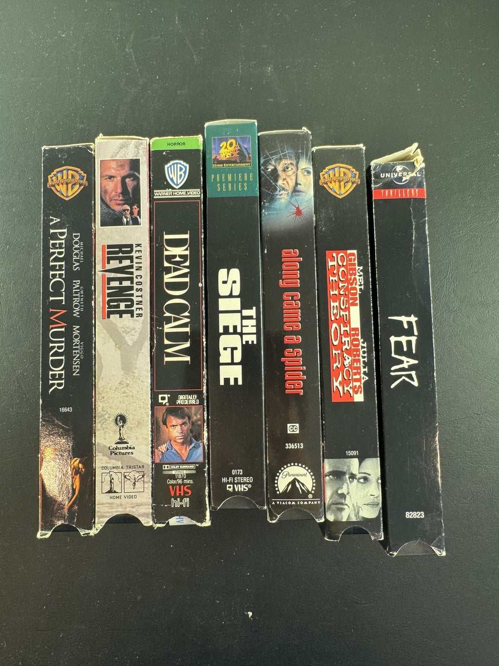 Set of 7 90s suspense thriller VHS tapes including Conspiracy Theory and A Perfect Murder.