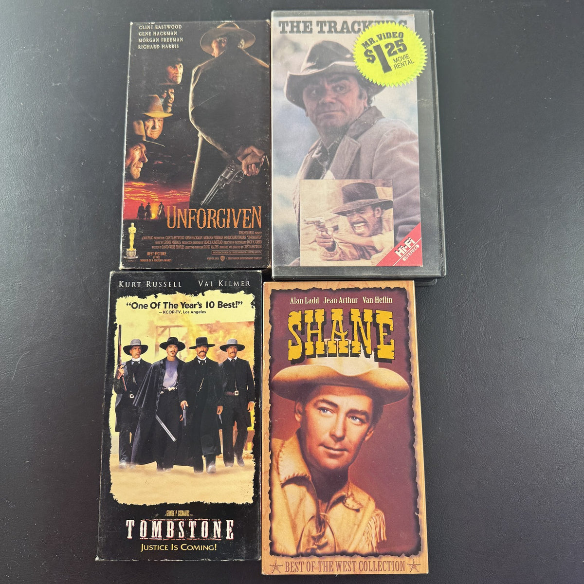 Set of 4 vintage Western VHS tapes including Tombstone, Unforgiven, Shane, and The Trackers