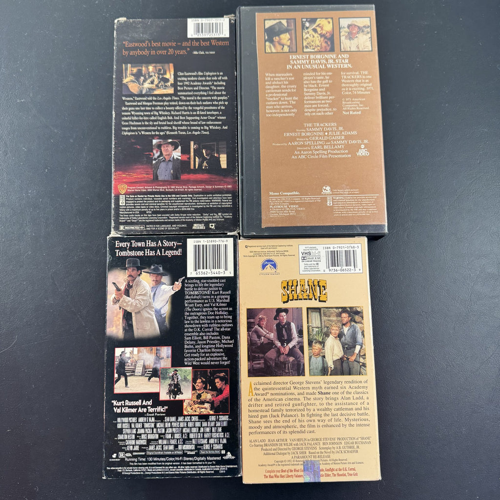 Set of 4 vintage Western VHS tapes including Tombstone, Unforgiven, Shane, and The Trackers