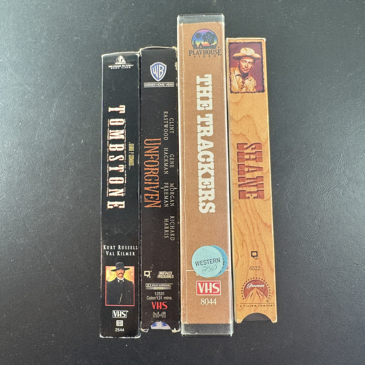 Set of 4 vintage Western VHS tapes including Tombstone, Unforgiven, Shane, and The Trackers
