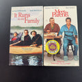 Set of two vintage comedy VHS tapes featuring Meet the Parents and It Runs in the Family in original slipcases.