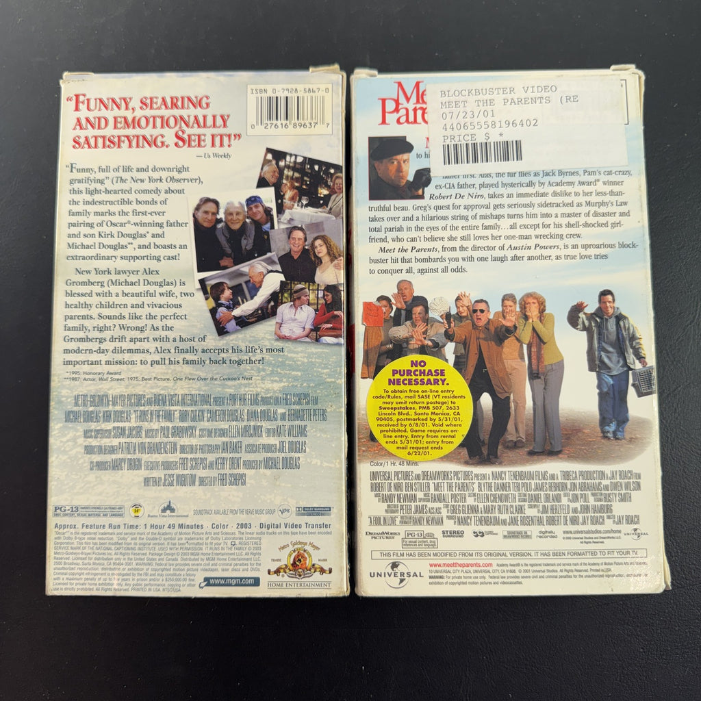 Set of two vintage comedy VHS tapes featuring Meet the Parents and It Runs in the Family in original slipcases.