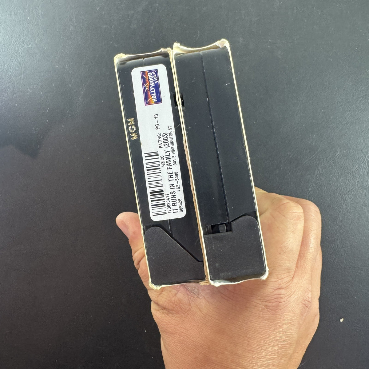 Set of two vintage comedy VHS tapes featuring Meet the Parents and It Runs in the Family in original slipcases.