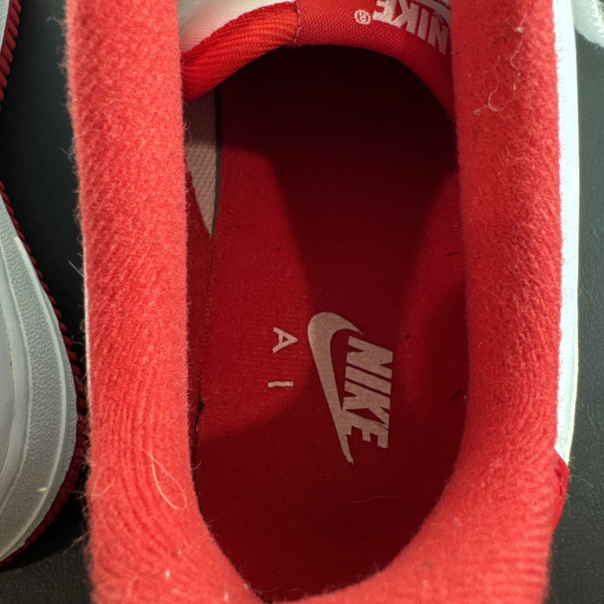 Nike Air Force 1 Low sneakers in White and University Red leather, Youth size 7Y.
