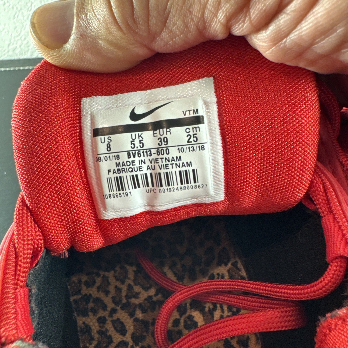 Nike Air Max 97 Leopard Pack red sneakers in women's size 8 showing low-top synthetic upper and outsole detail